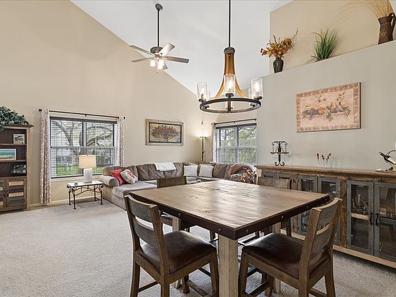 Dining area features a high-top table with seating for six.