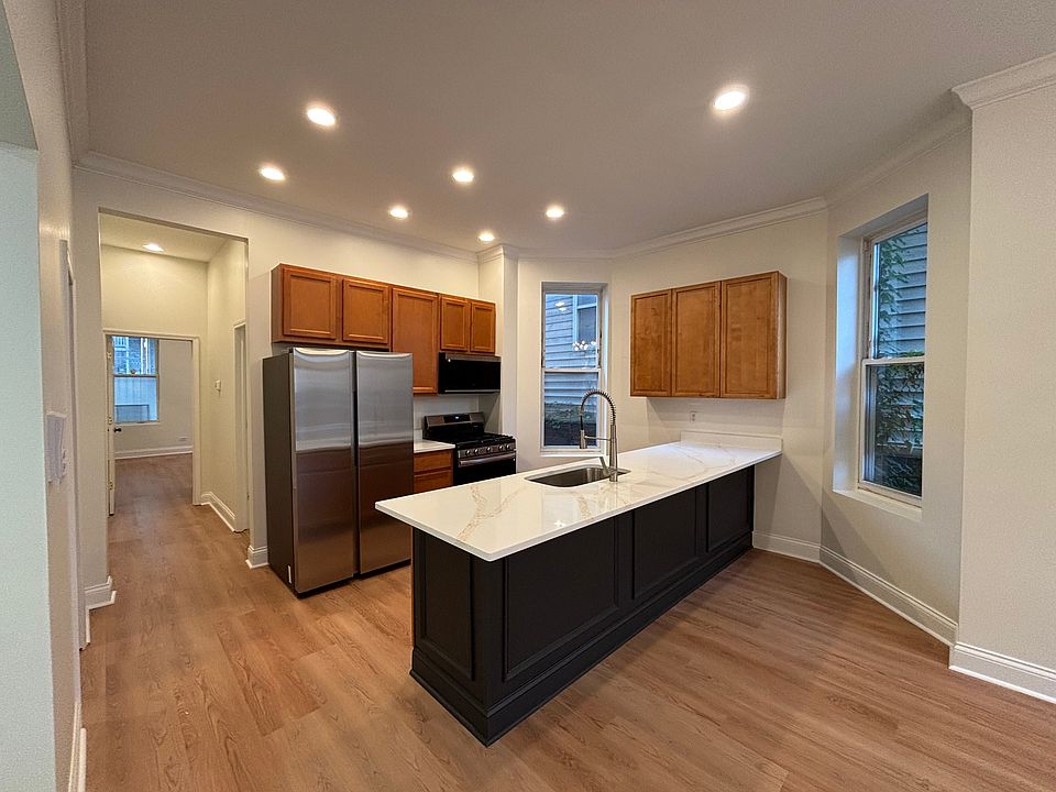 Main level kitchen with new quartz countertops and stainless steel appliances