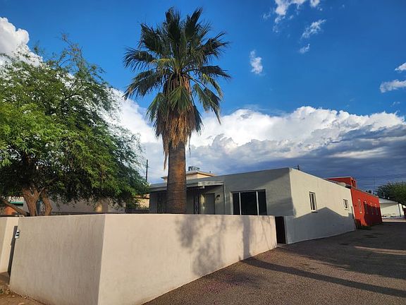 Front yard wall and driveway from northwest