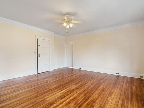 Living room with high ceilings and gleaming wood floors