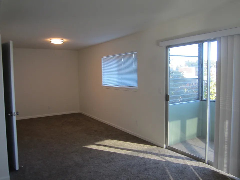 Living room from entrance with solar atrium on left