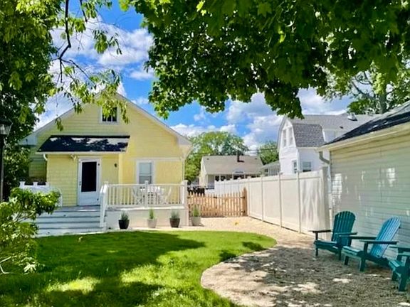 Quiet, fenced in backyard with new large deck, driveway gate and fire-pit area with lounge seating.