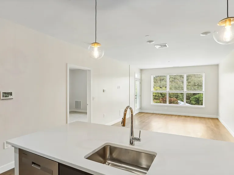 The Oak Floor Plan Kitchen Island and Living Room