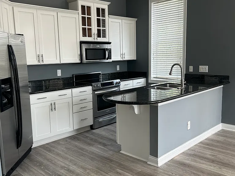 Open kitchen floor for guest entertainment. Stainless steel appliances.