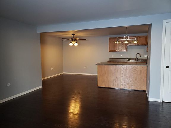 Open plan living room with view of dinning area, freshly painted & new hard wood floor.