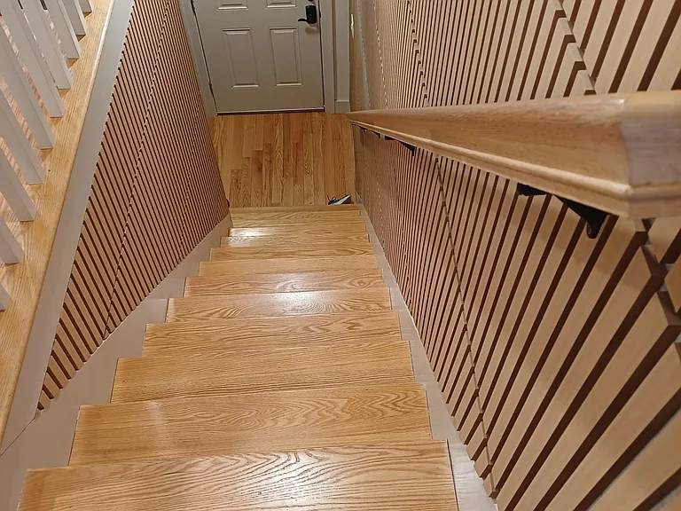 Stairs from 2nd floor down to entrance door (view from above)