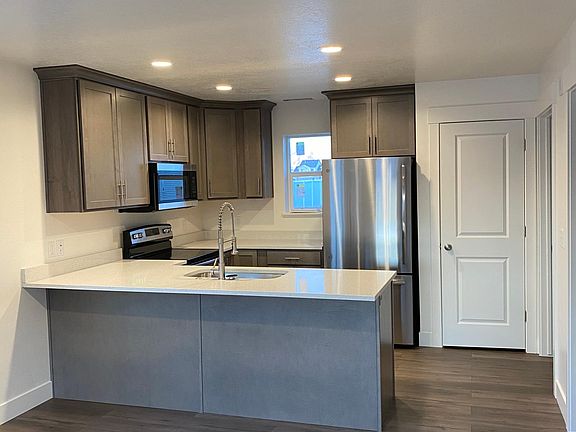 Kitchen w/ beautiful quartz countertop and recessed LED lighting