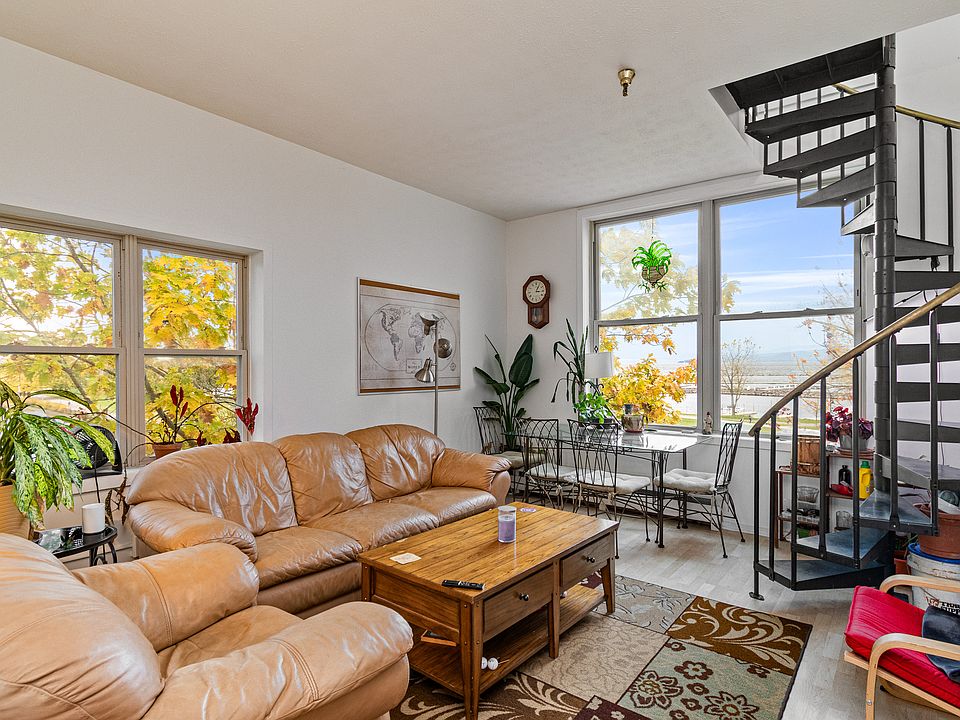 The open living room features giant windows facing west with views across lake Champlain to the Adirondacks.