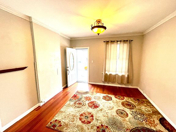 Front room - view of front door with hardwood flooring and lighting