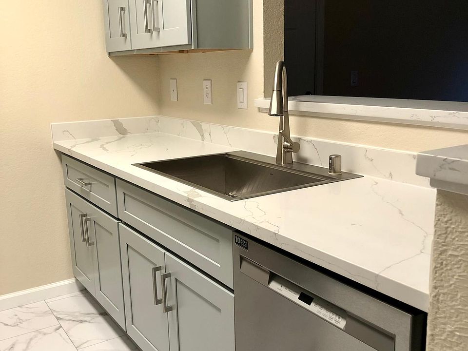Stainless steel dish washer, 33 inch Gruss rectangle sink. Two pull out trash bins under the sink.