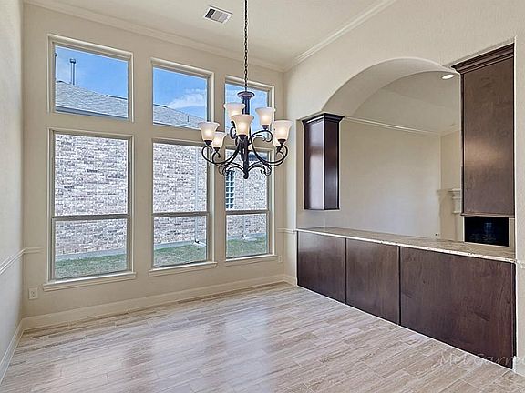 Spacious formal dining space is still convenient to the kitchen and entertaining areas.