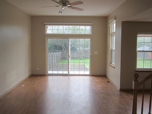 Looking at the sliding back door from the front entry area. 10 foot ceiling in living room and ceiling fan
