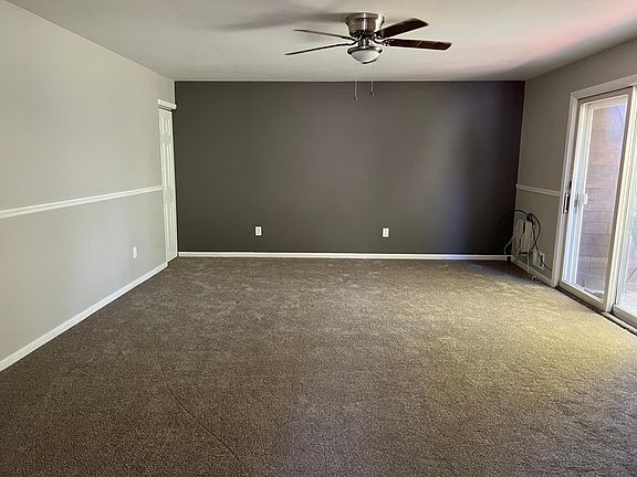 Stairs from front door lead you into living room with large hall double closet and small deck off room