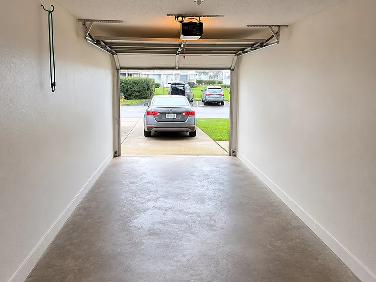 Private one-car garage with additional storage space.