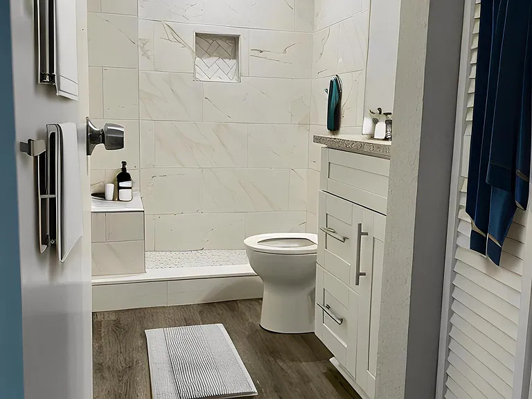 Luxury bathroom with large tiled shower & bench. Large linen closet for additional storage.