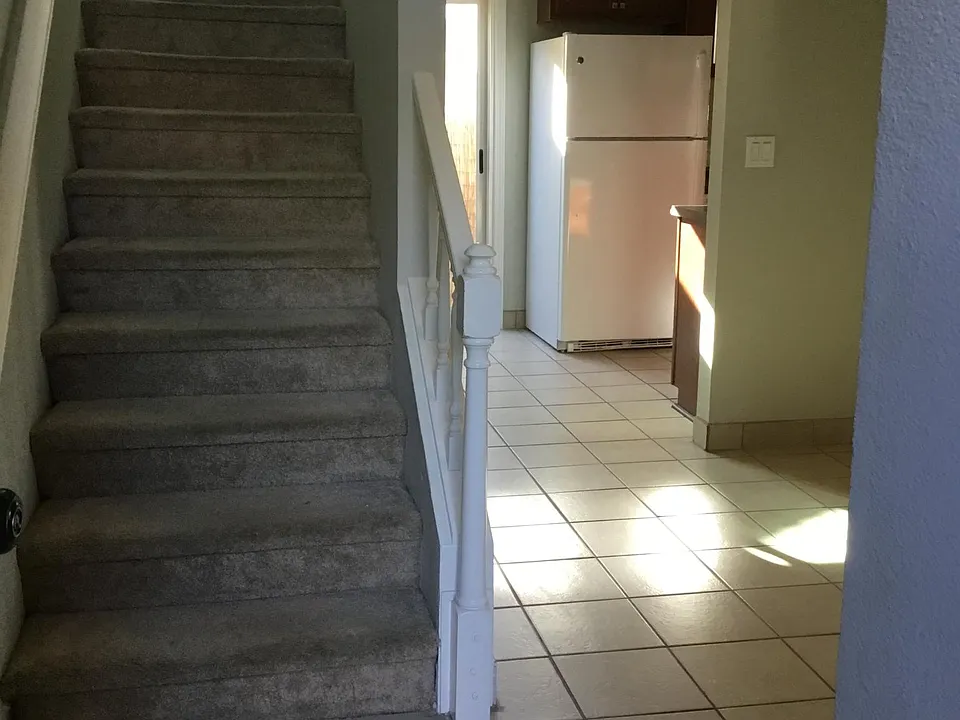Entry. Loft, bedroom and bath are upstairs. Living room to the right. Kitchen and private patio straight ahead.