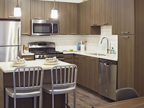 Sleek color scheme: modern quartz counter-tops and dark espr