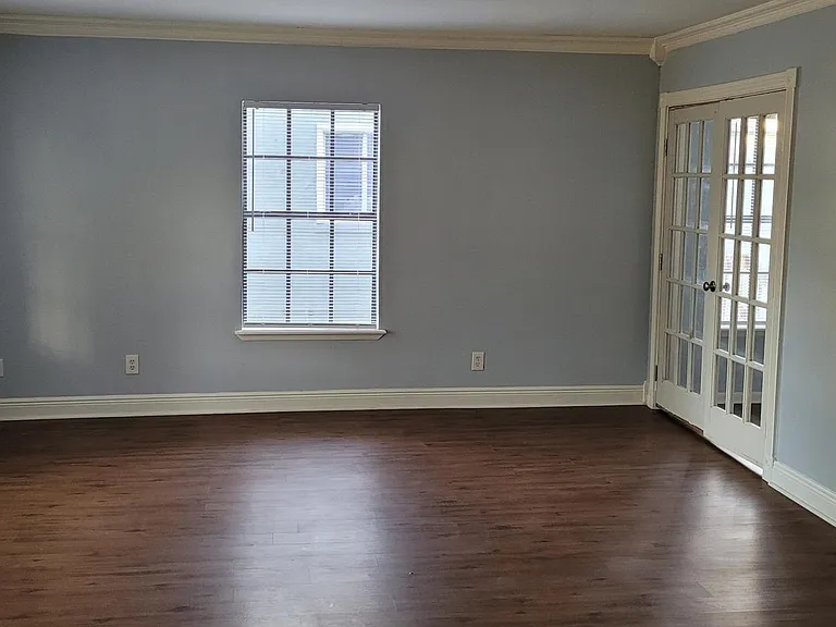 Downstairs large, formal living room. The office is shown to the right off the living room.