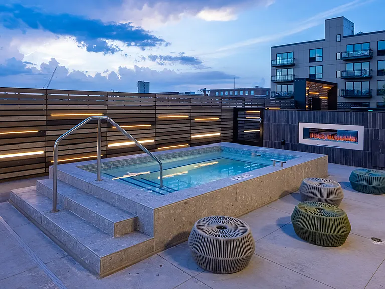 Year-round spa with fireplace at dusk