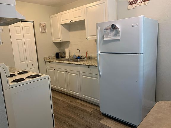 Unit 1A - Updated kitchen with new cabinets and subway backsplash. Fully equiped kitchen comes with cookware, small electrics, cooking utensils, silverware, glasses and plates.