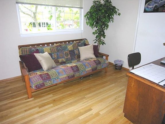 Spare bedroom with hardwood floors.