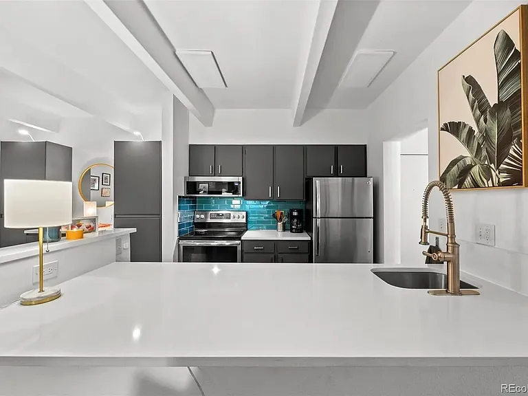 Main view of kitchen with microwave, electric stove/oven and refrigerator