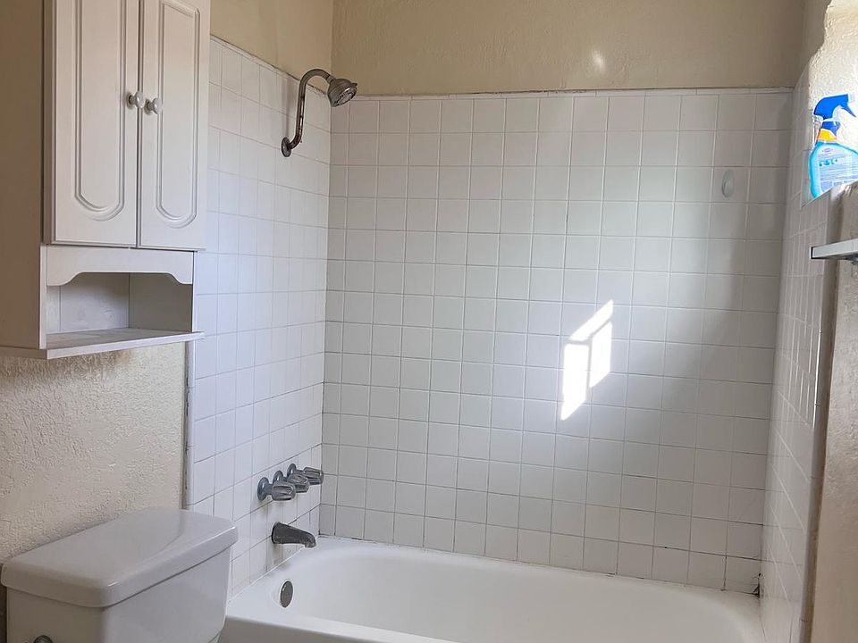 Bathroom with full tub and tile floor