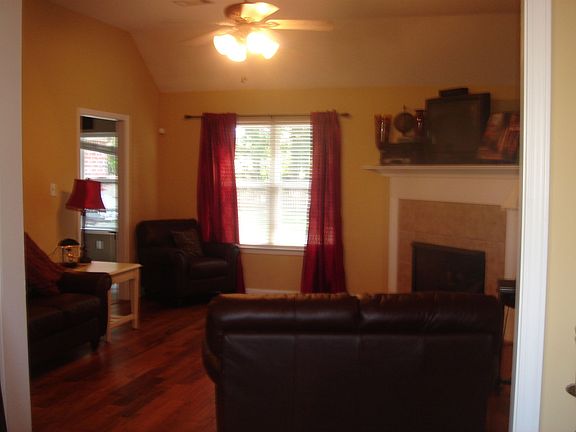 Living Room with wide plank hardwood floors and fireplace!
