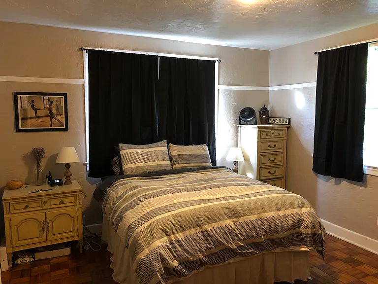 Back bedroom with prior tenant's furnishings