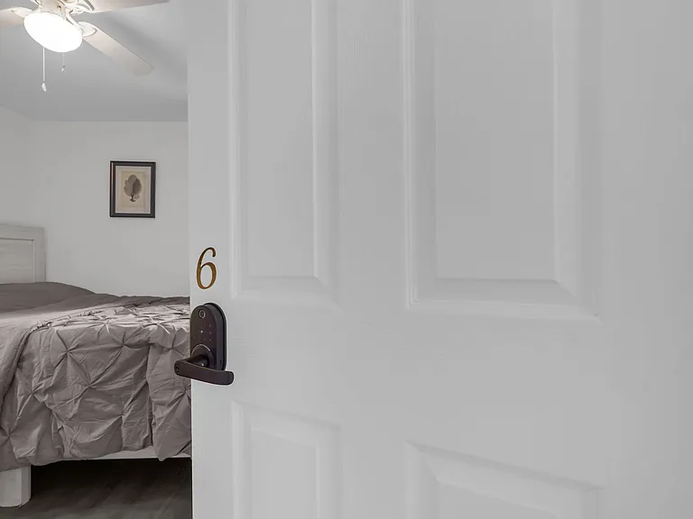 Private bedroom with a comfortable bed setup, ceiling fan, and neutral finishes for easy move-in and everyday comfort.