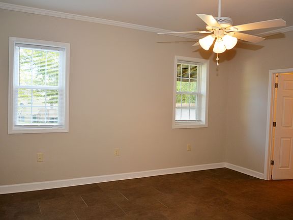 Large bedroom with a double closet and ceiling fan.
