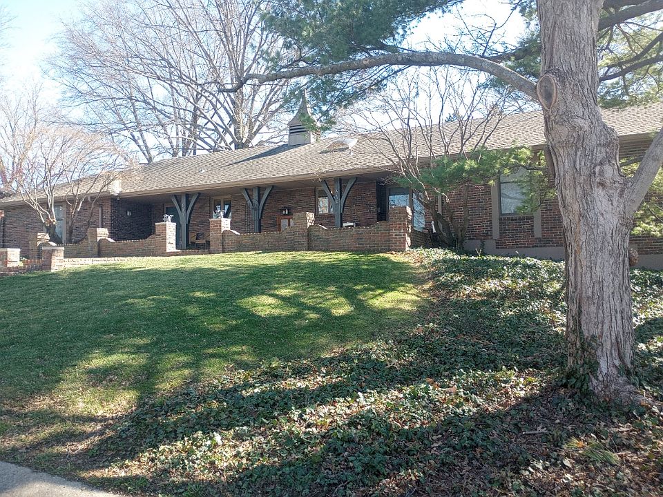 Brick duplex exterior on wooded lot