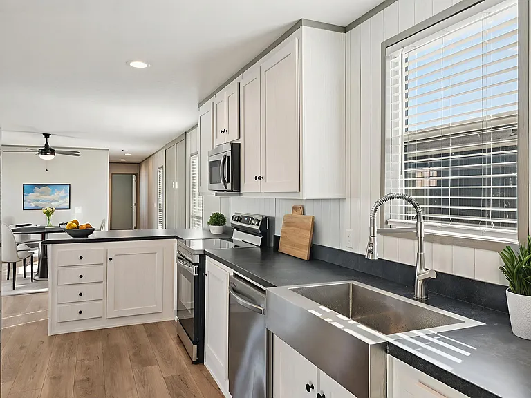 Modern kitchen with sleek countertops, stainless steel appliances, and ample cabinet space designed for both style and functionality.