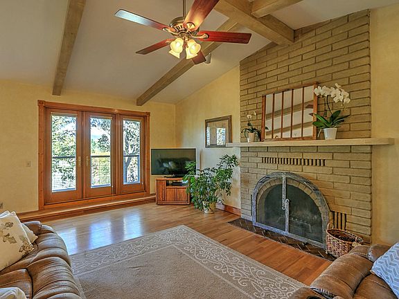 Living room with fireplace and doors to deck.