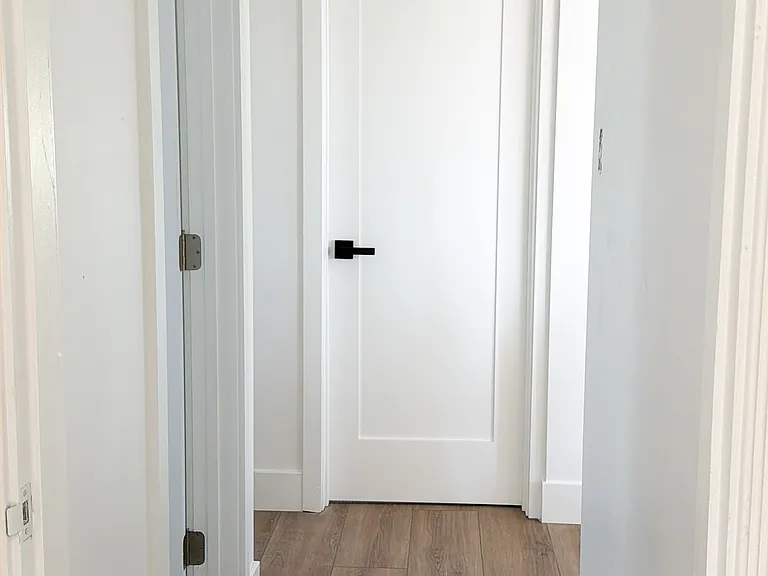 Hallway facing bedroom 2. Bathroom on the left and kitchen on the right.