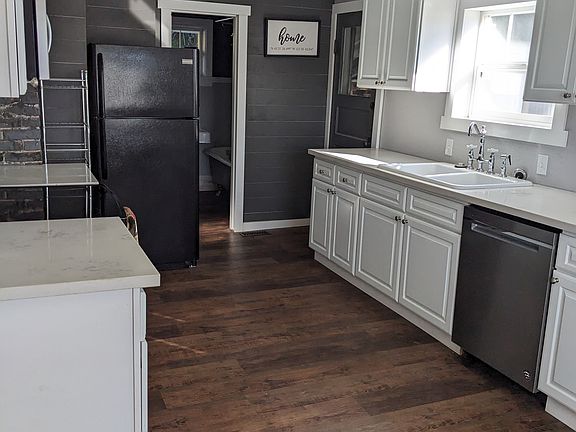 Kitchen with Dishwasher, Micro hood, Refrigerator, Electric Range Oven, and Garbage Disposal.