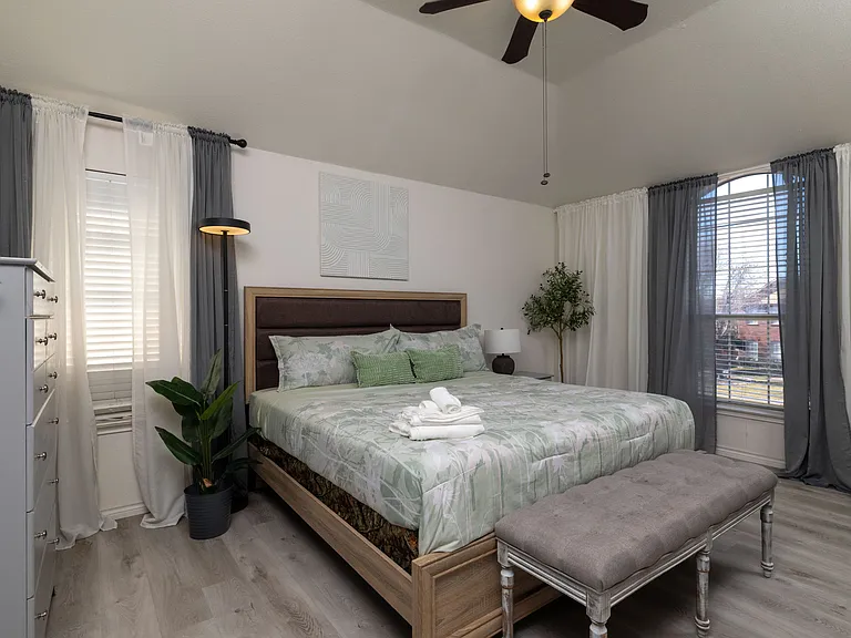 Cozy bedroom with a king bed and nature-inspired decor.