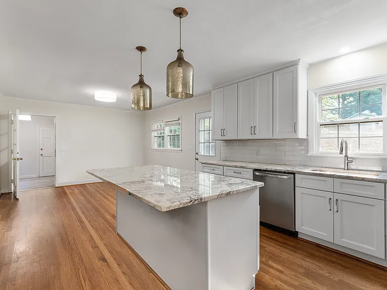 Kitchen opens to dining room with adjacent office.