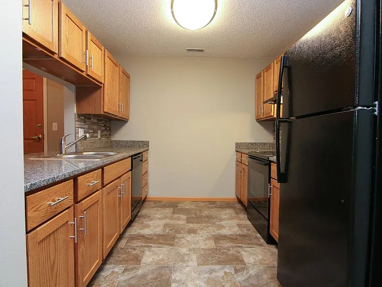 Updated kitchen with sleek black appliances and spacious countertops adorn our renovated apartments.