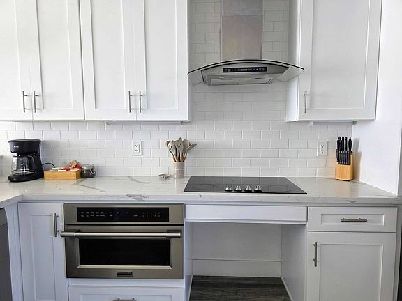Fully equipped kitchen. Stove, Oven, and a coffee maker