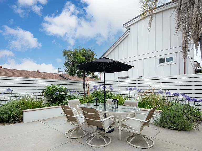Backyard patio area is gated and features a new gas bbq grill and seating area. Great for family get together and entertaining!