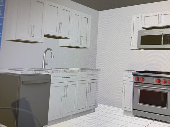 New kitchen with stainless appliances and quartz countertops under construction.