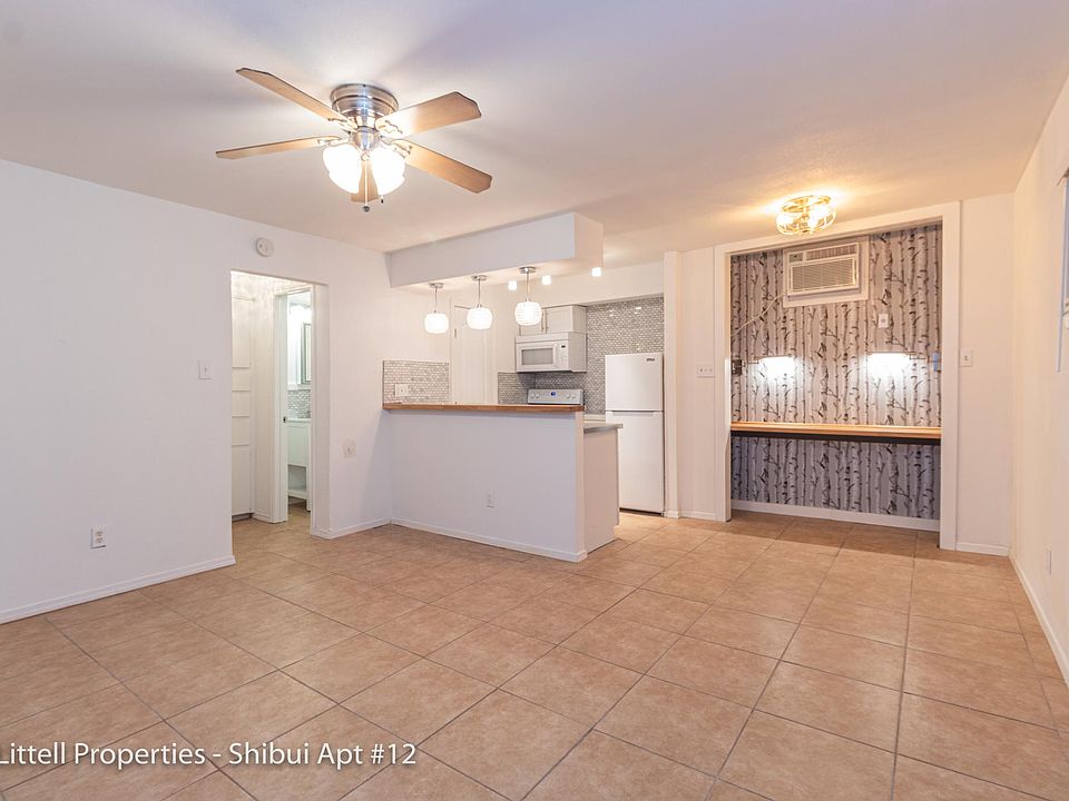 The unit has light brown tile floor throughout the living space and kitchen. It has ample lighting and a ceiling fan.