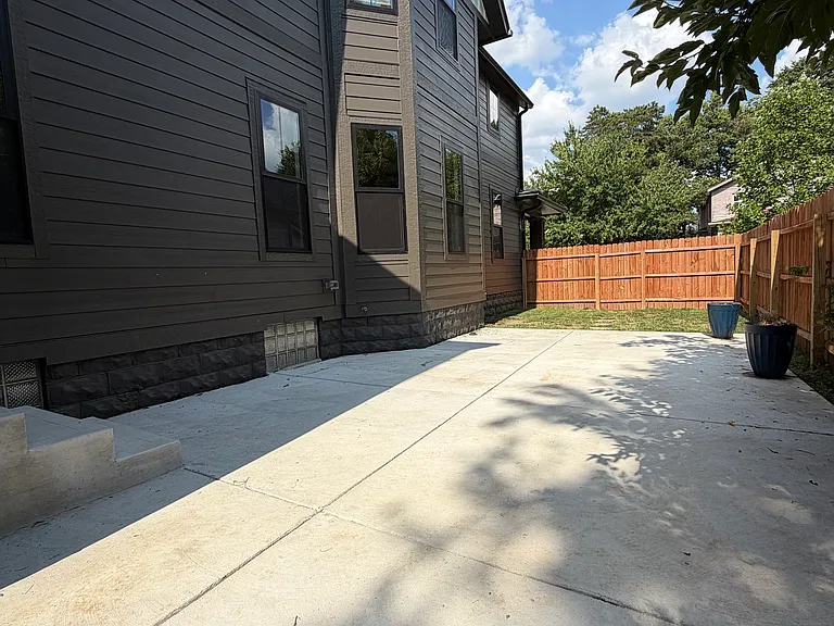 spacious concrete patio and privacy fence