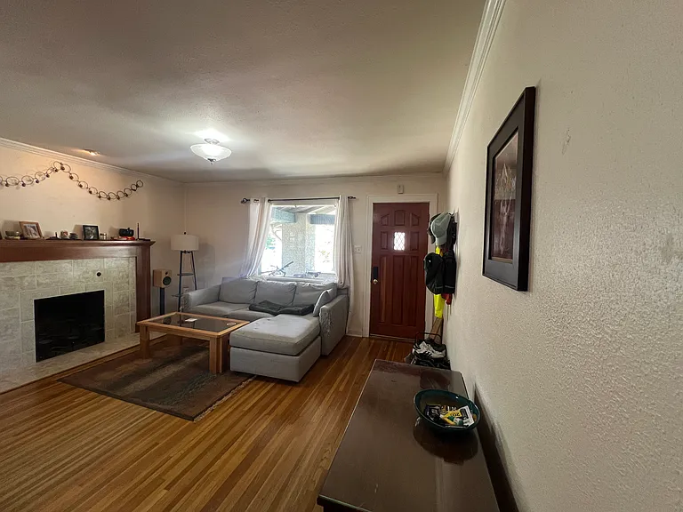 April 2026-Looking backward toward living room and front door with large north window overlooking porch and narrow, quiet road.