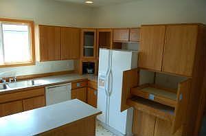 TONS of storage w/ pull outs and even a lasy susan!  Side-by-side, dishwasher, glass top stove all included!