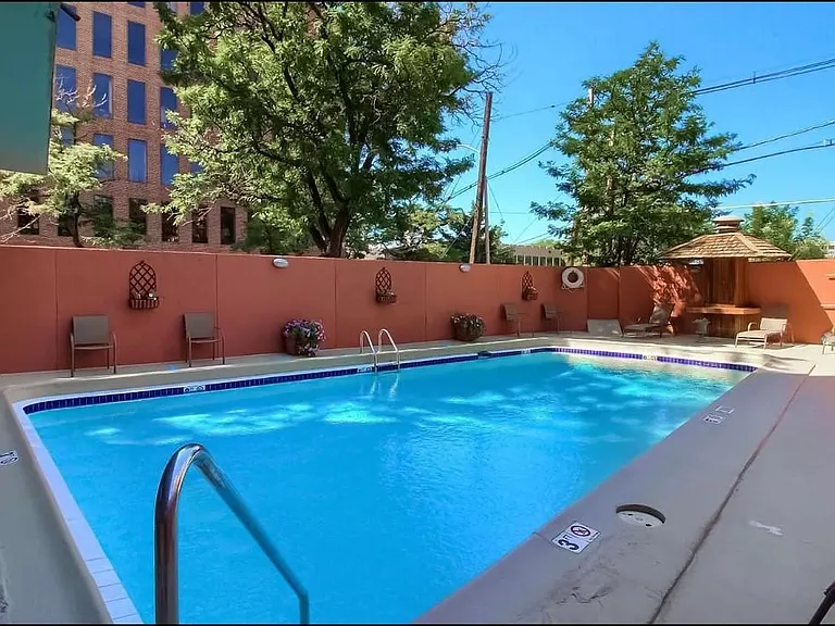 Outdoor pool with lounge seating and cabana areas.