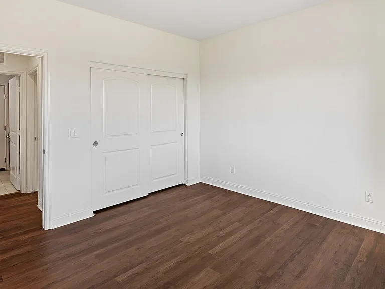 Spare Bedroom 1 Downstairs with Fan and closet next to the Full Bath