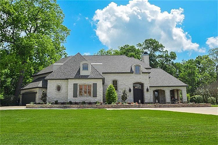 This Magnificent French Country Estate is located on a Gorgeous One Acre Wooded Waterfront Lot in the Upscale Estate Section of Weston Lakes.