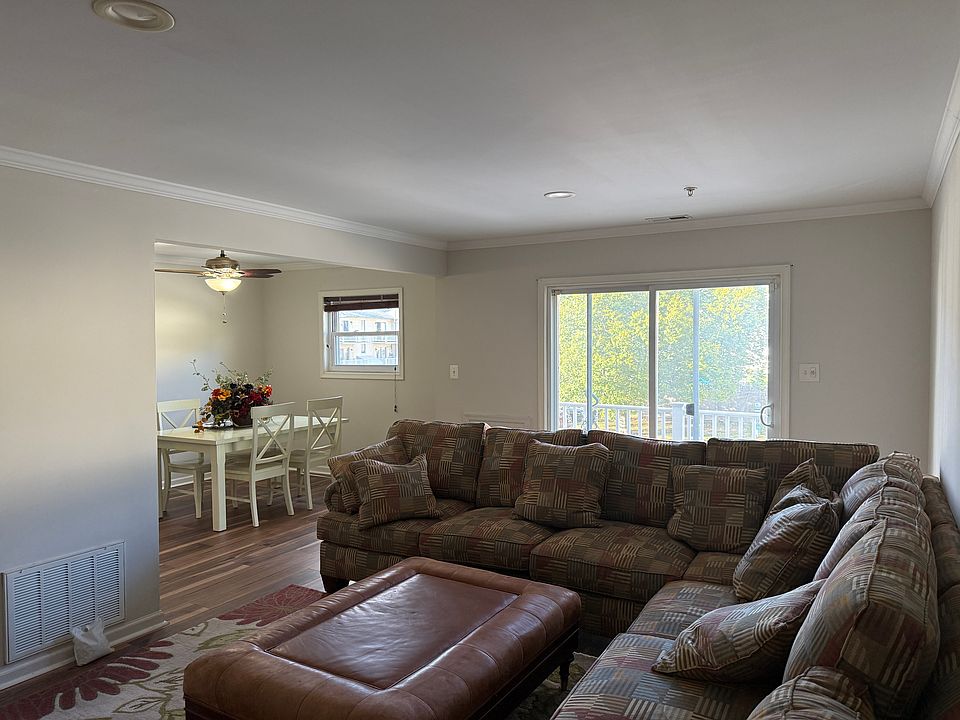 Entering in front door looking at the living room, kitchen and out the balcony